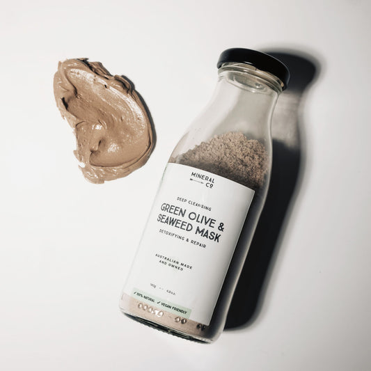 Bottle of Clay Face Mask - Green Olive & Seaweed , with smear of mask clay